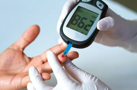 Patient checking blood glucose levels with a digital glucometer for advanced diabetes monitoring