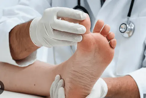 Medical professional examining a patient's foot layout for diabetic foot ulcer screening